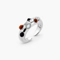 Adjustable platinum-plated ring with multiple oval cabochon stones in black, amber, and white tones on neutral background.