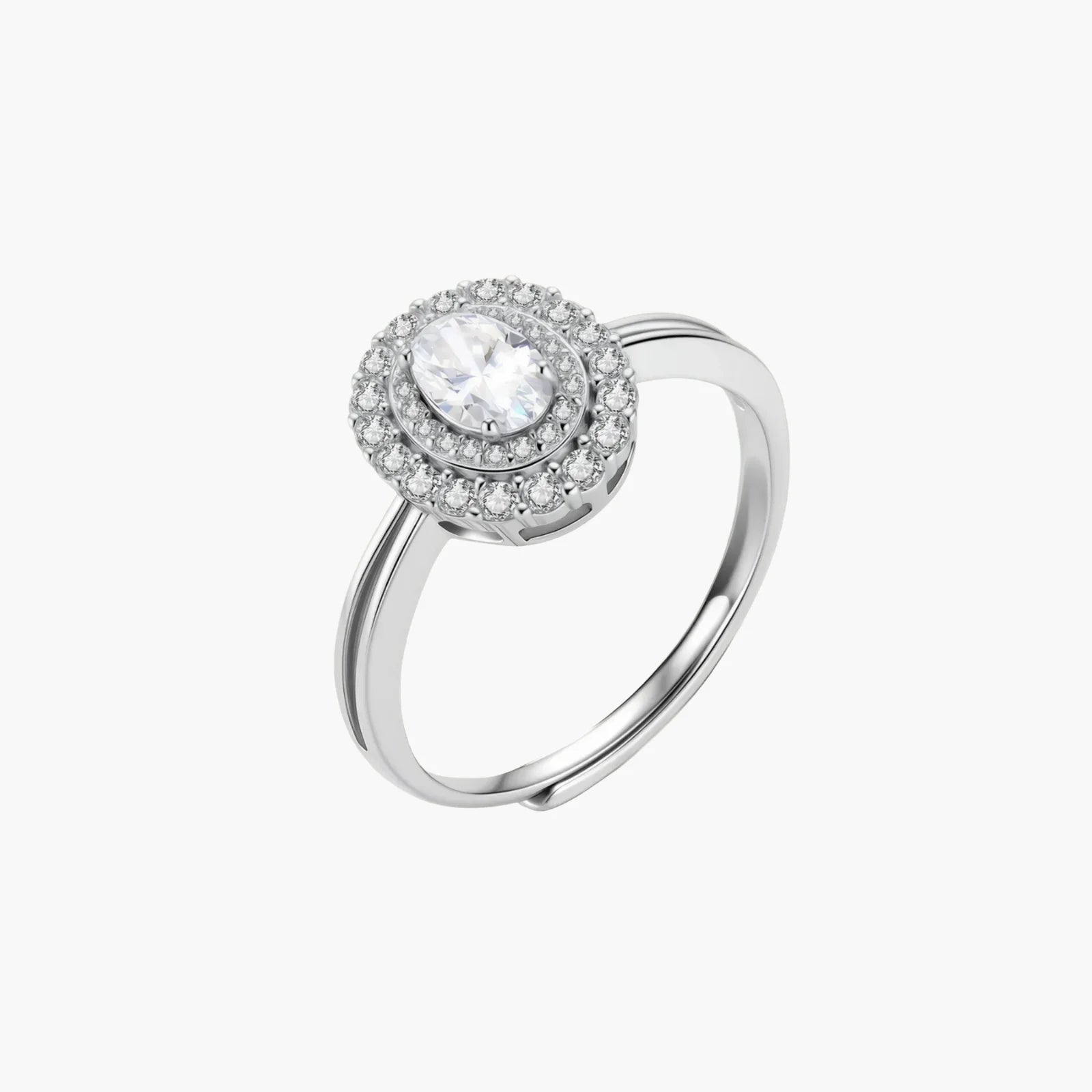 Sterling silver ring with oval moissanite center stone surrounded by double halo of sparkling stones on neutral background.