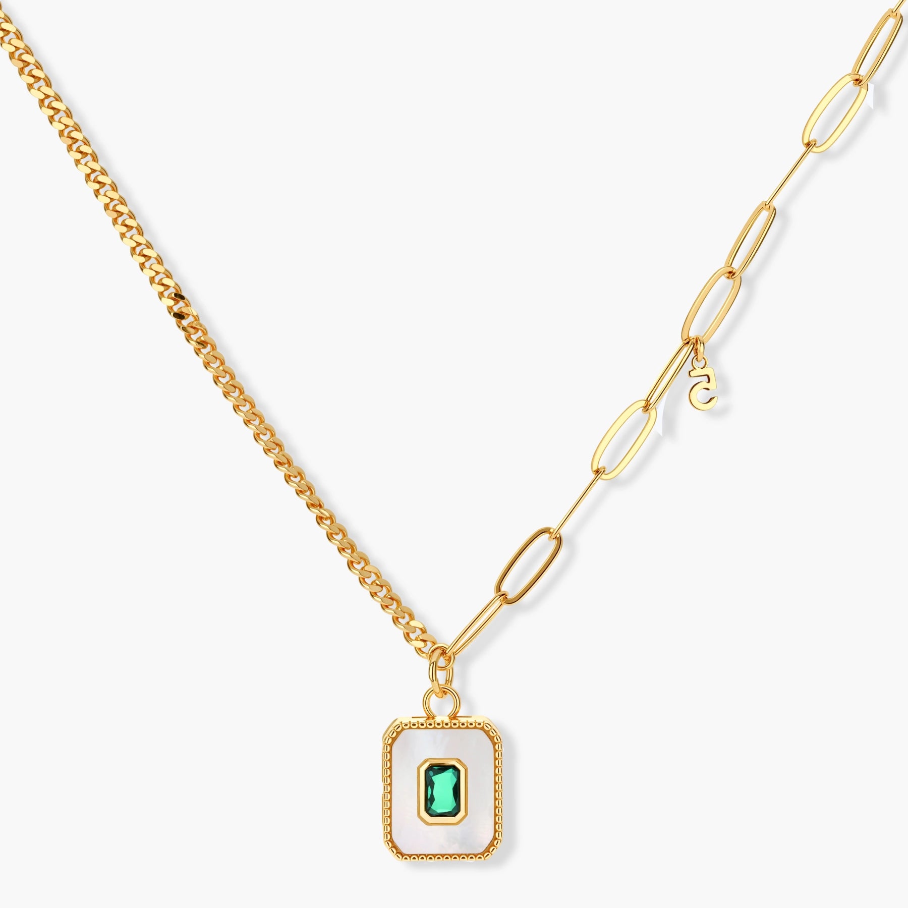 Gold-plated jewelry set with white enamel square pendants and emerald CZ stones on cream background.