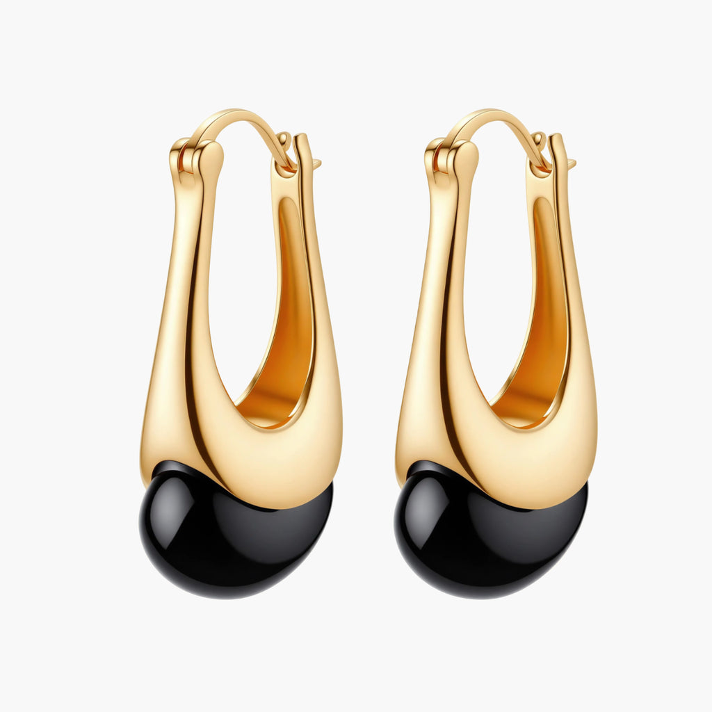 Gold-plated drop earrings featuring black agate stones with hoop closure on white background, showing elegant teardrop design.