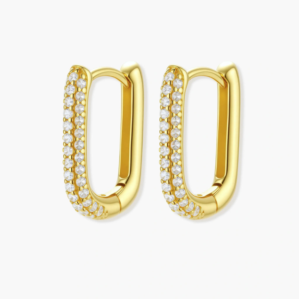 Close-up of gold-plated sterling silver huggie earrings with pave-set crystals creating a continuous sparkle around the hoop
