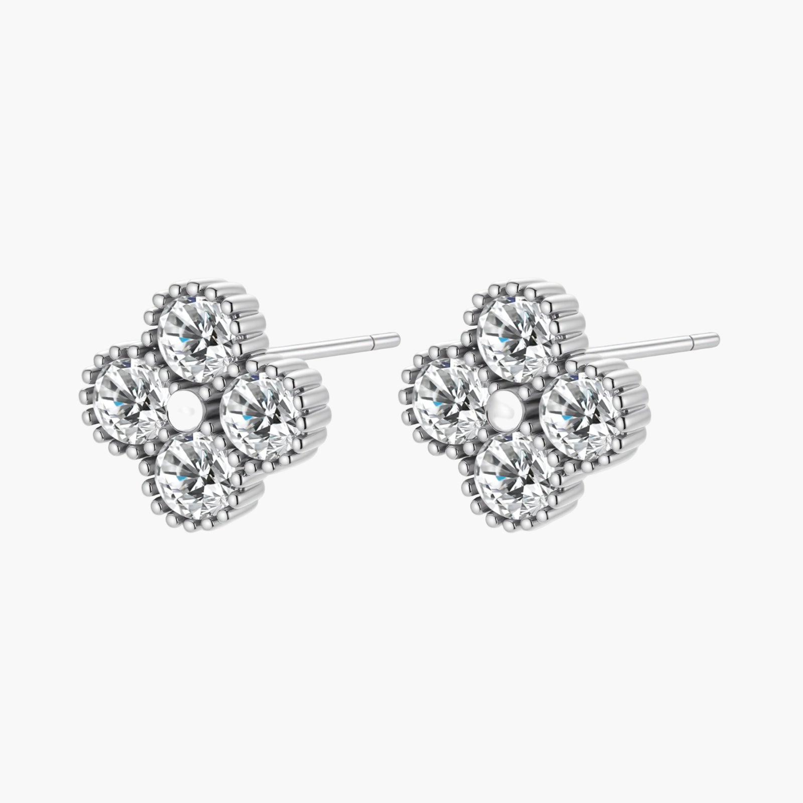 Dainty sterling silver quatrefoil stud earrings with four brilliant moissanite stones and center accent on white background.