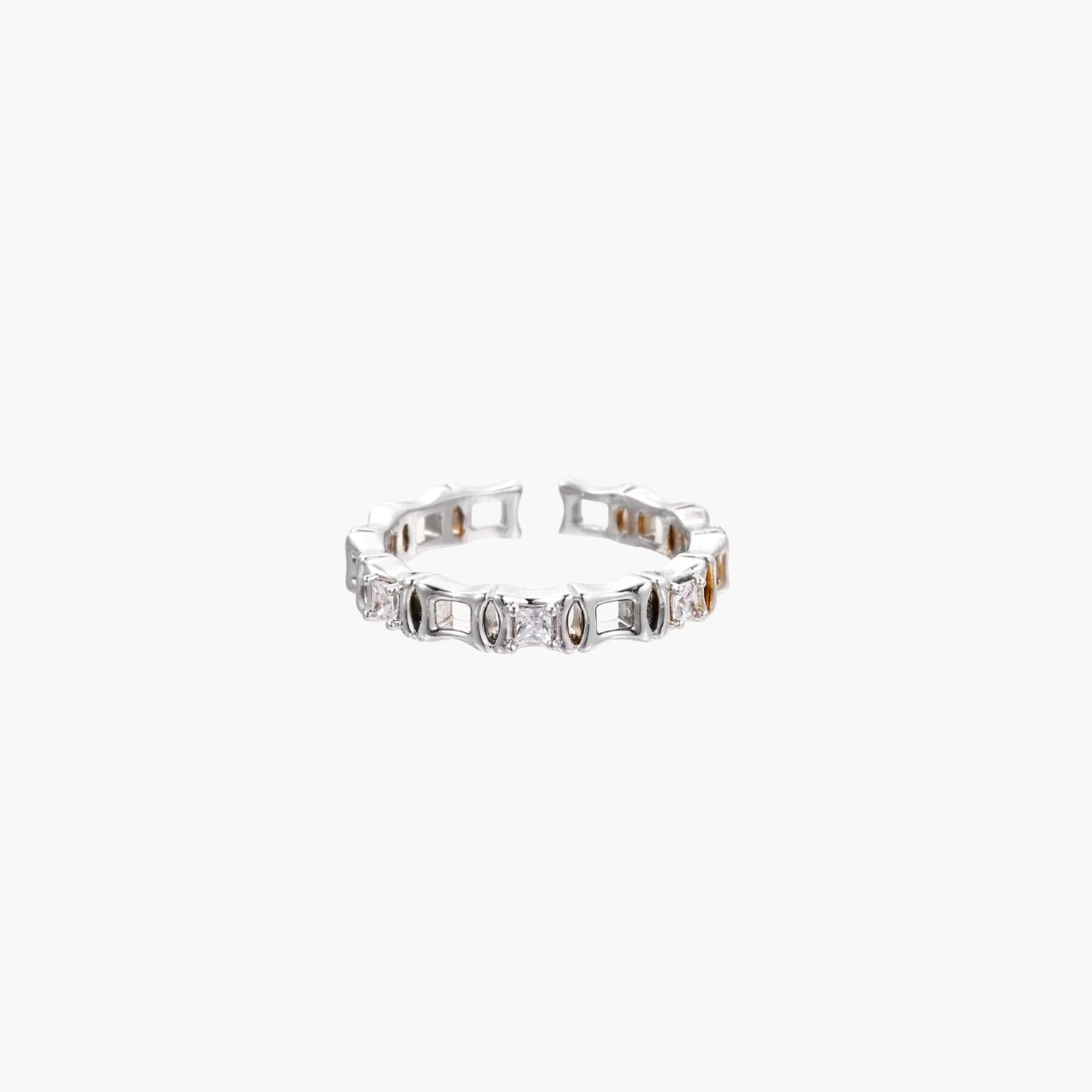 White gold plated ring with architectural lattice design and zirconia accents on cream background