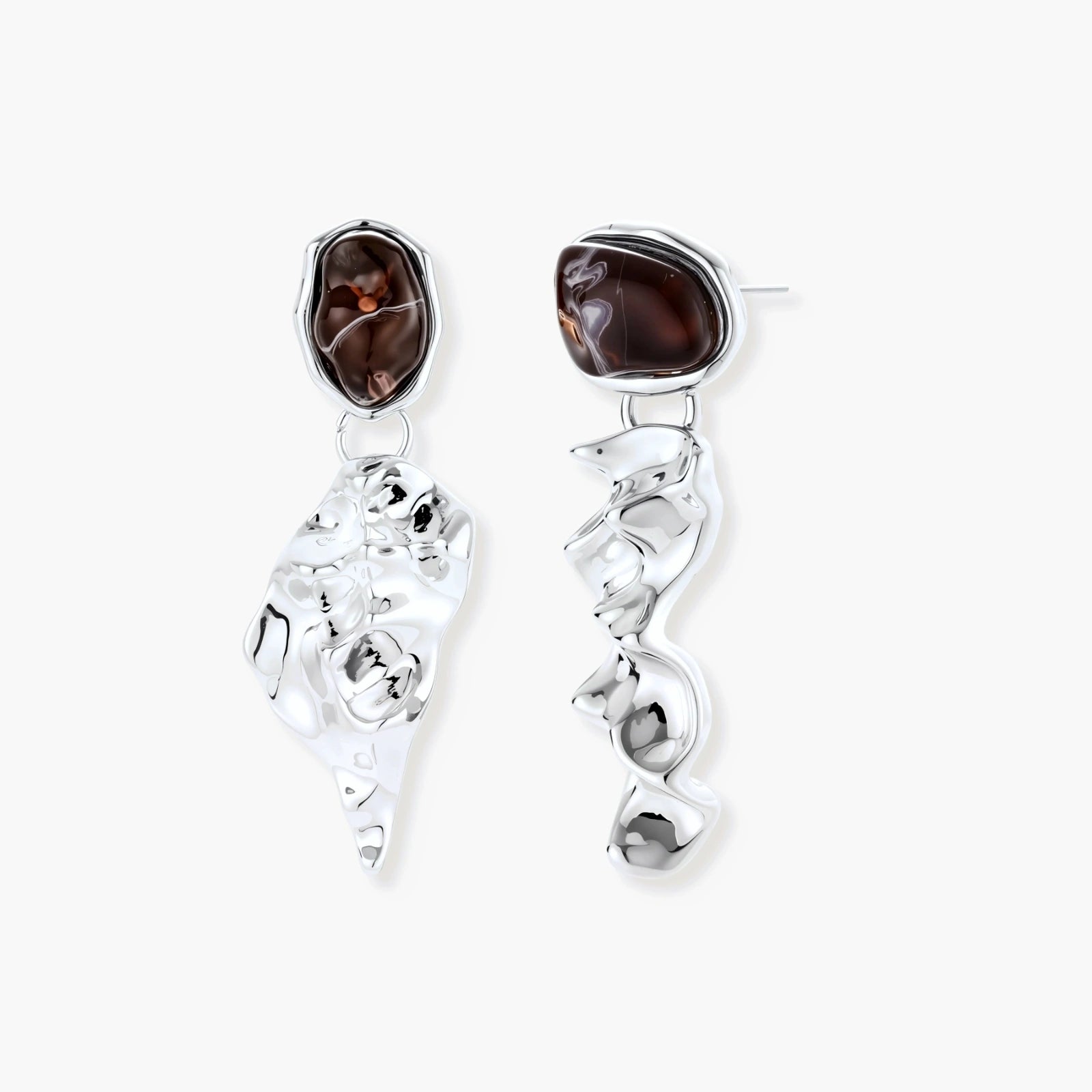 Abstract sculptural silver earrings with brown resin stones featuring organic fluid metalwork design on white background.