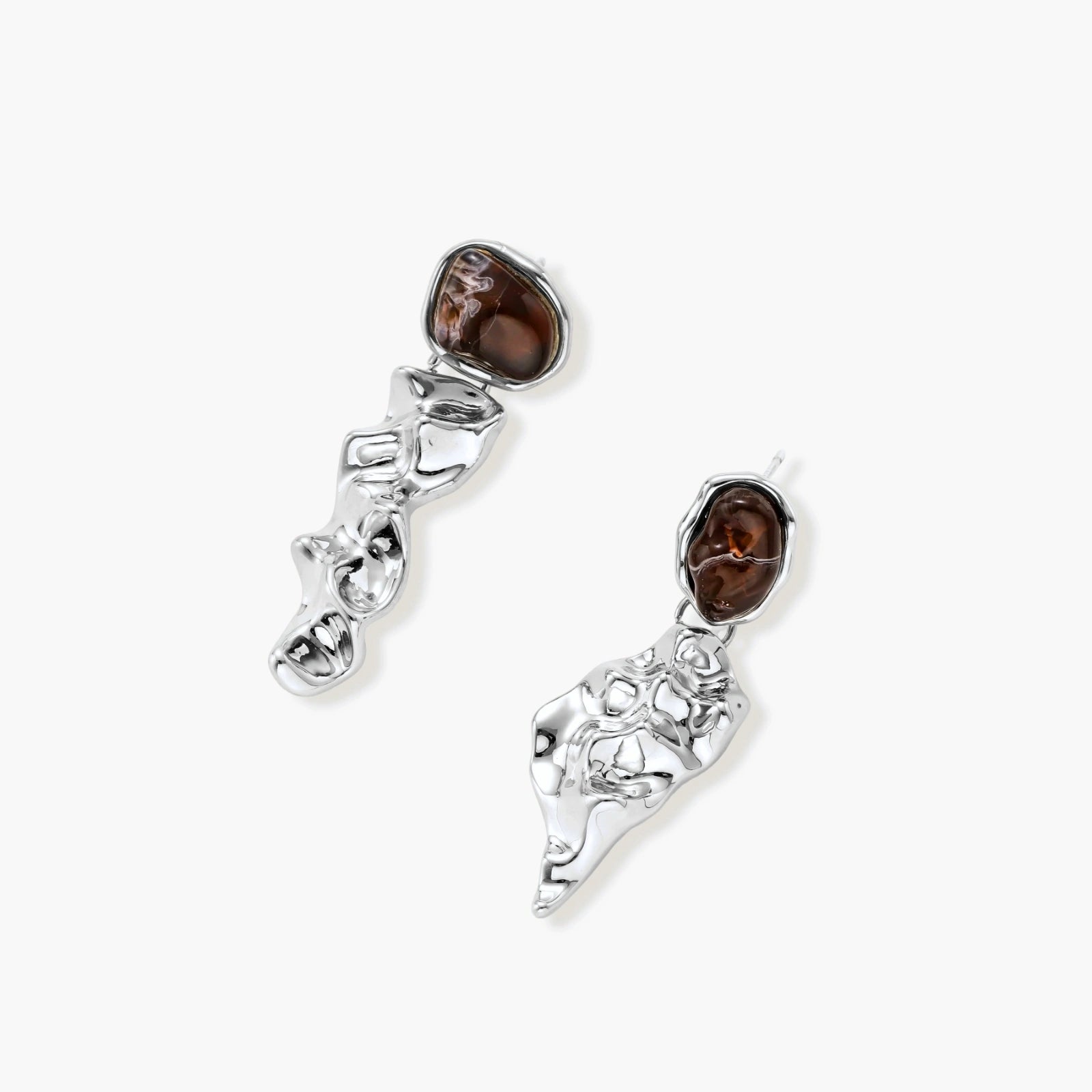 Abstract sculptural silver earrings with brown resin stones featuring organic fluid metalwork design on white background.