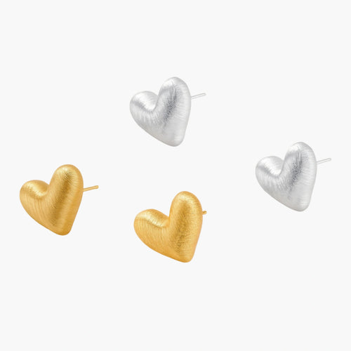 Pair of textured heart-shaped stud earrings in brushed platinum-plated sterling silver against cream background.