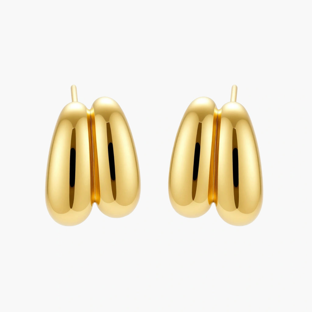 Chunky 18K gold-plated sterling silver hoop earrings with flowing sculptural curves on white background.