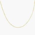 Delicate gold-plated sterling silver chain necklace with geometric segments displayed against cream background