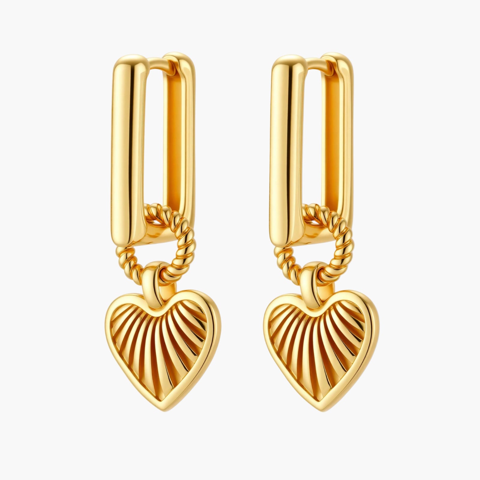 Gold-plated huggie earrings with textured heart charms featuring radiating sunburst patterns on white background.