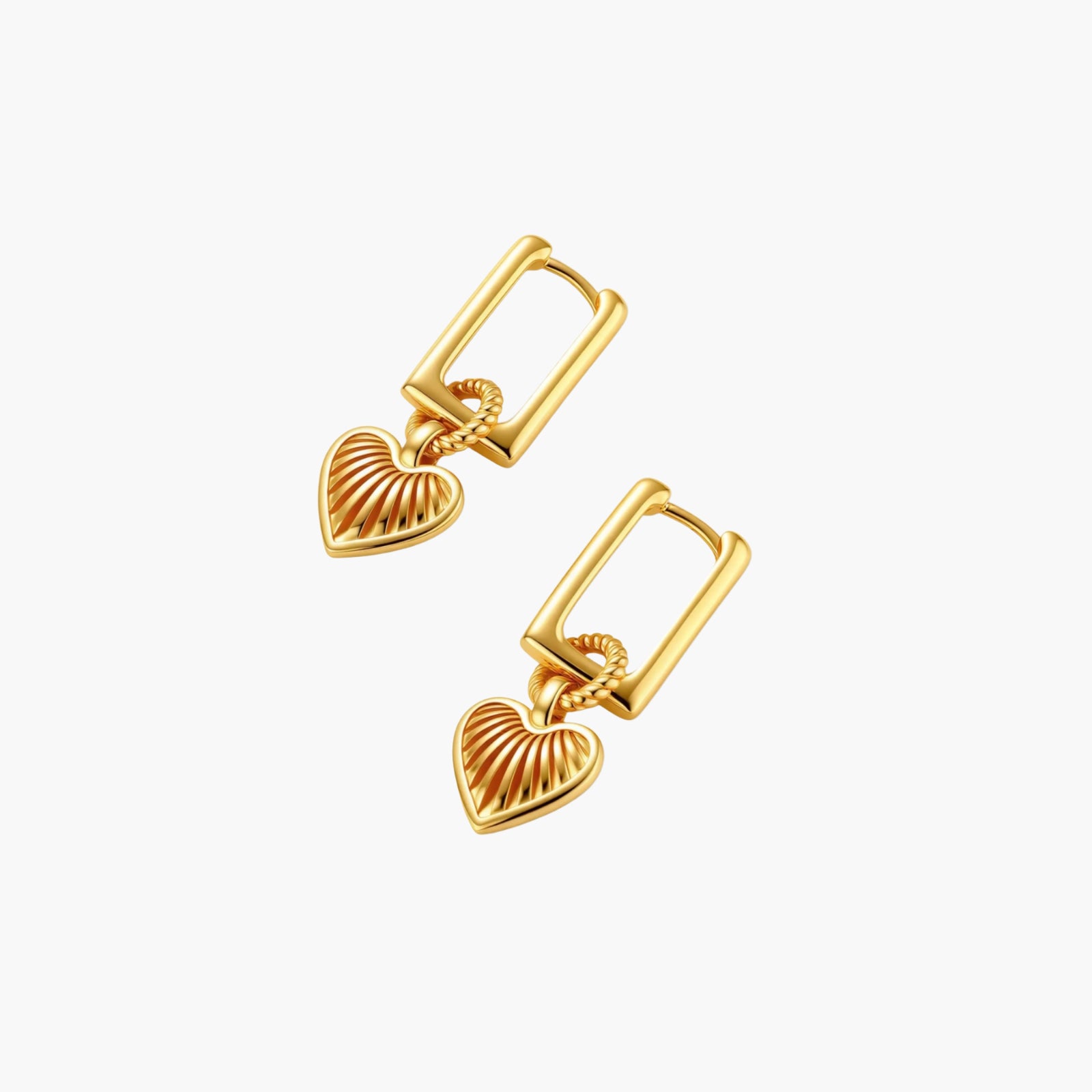 Gold-plated huggie earrings with textured heart charms featuring radiating sunburst patterns on white background.