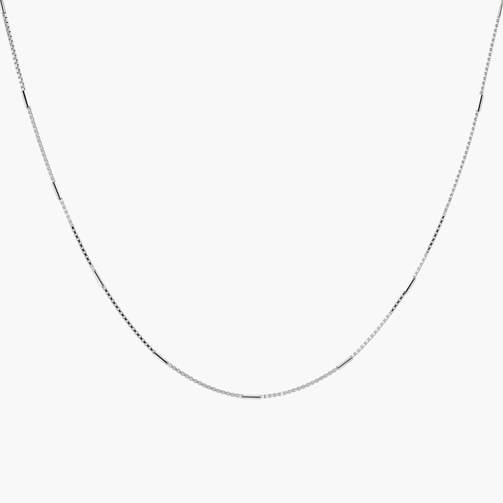 Delicate platinum-plated sterling silver necklace with alternating textured cubic links and smooth chain sections.