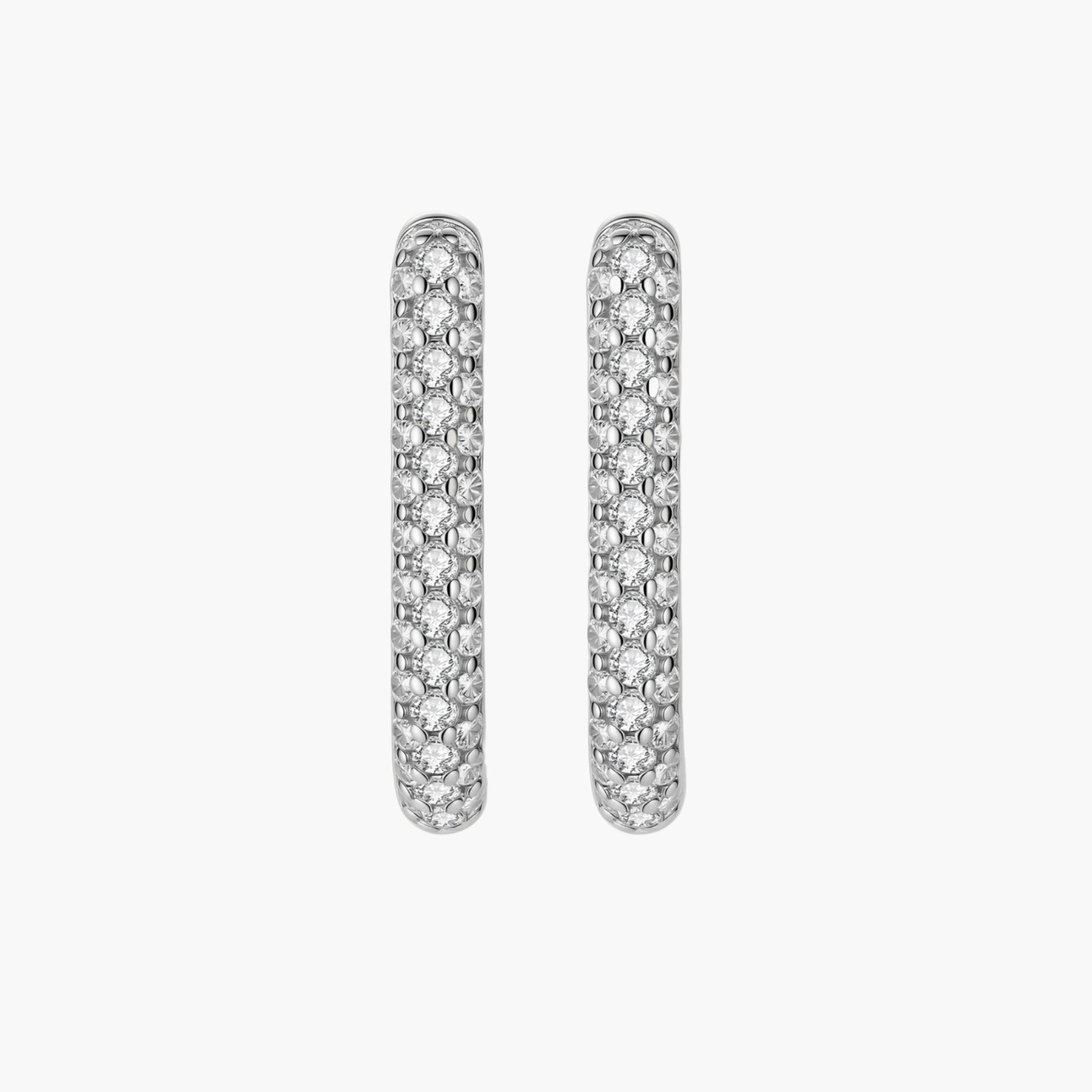 Close-up of platinum-plated sterling silver huggie hoops with pavé crystal setting on white background.