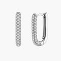 Close-up of platinum-plated sterling silver huggie hoops with pavé crystal setting on white background.