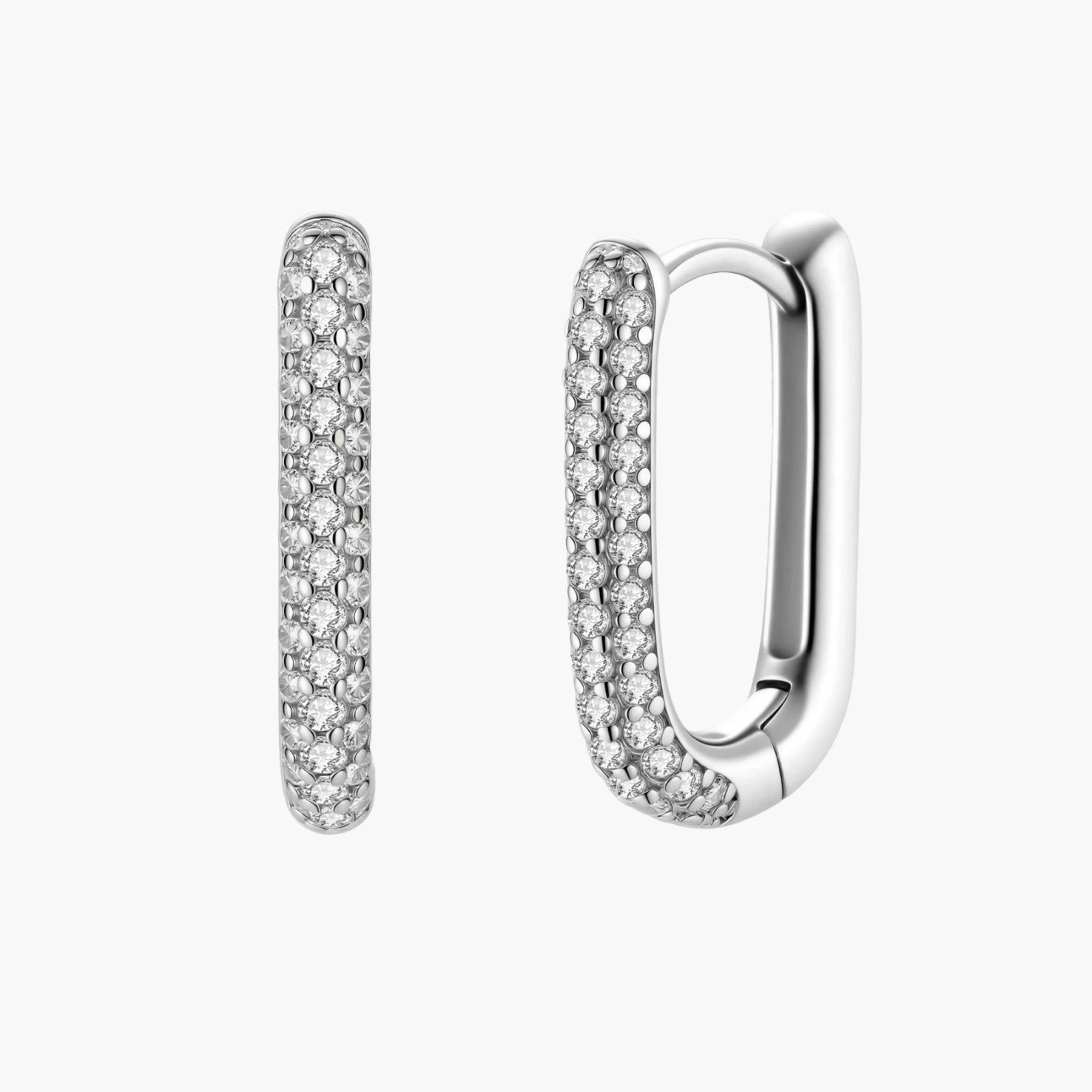 Close-up of platinum-plated sterling silver huggie hoops with pavé crystal setting on white background.