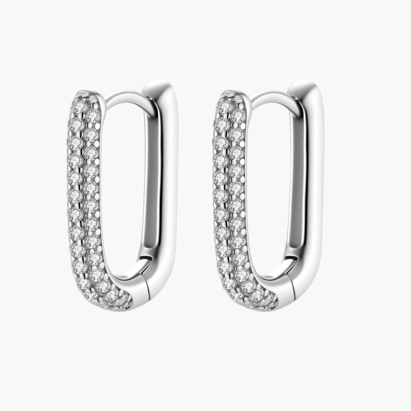 Close-up of platinum-plated sterling silver huggie hoops with pavé crystal setting on white background.