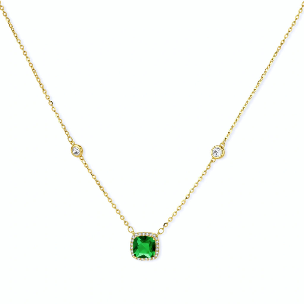 Delicate gold chain necklace featuring square emerald pendant with crystal halo and station accents