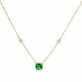 Delicate gold chain necklace featuring square emerald pendant with crystal halo and station accents