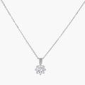 Platinum-plated sterling silver necklace with round clear crystal pendant and decorative bail on neutral background.