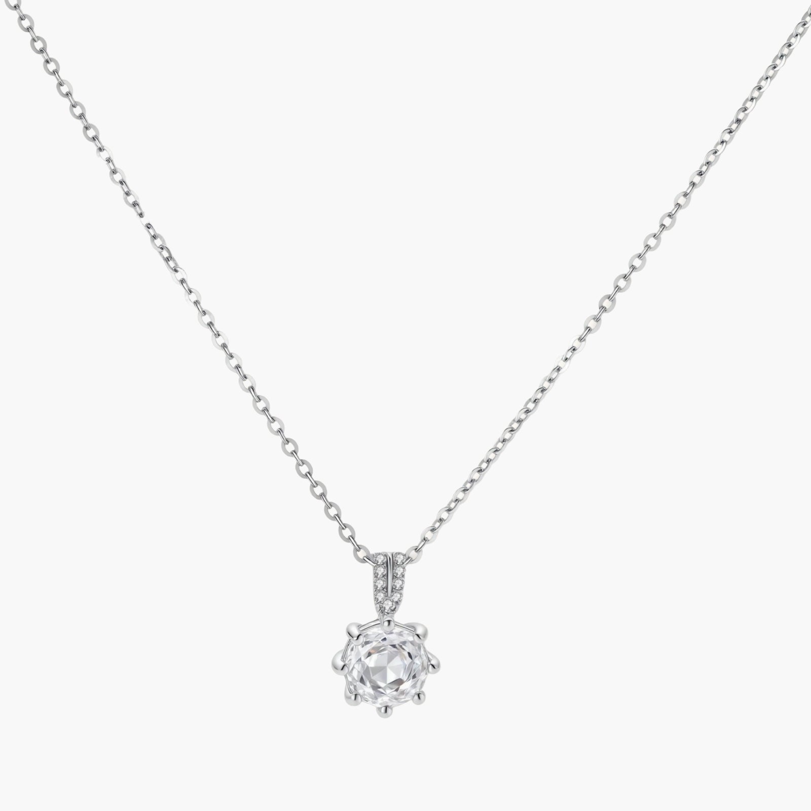 Platinum-plated sterling silver necklace with round clear crystal pendant and decorative bail on neutral background.