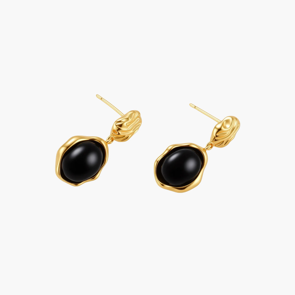 Gold-plated rippled stud earrings with black agate stone drops on white background