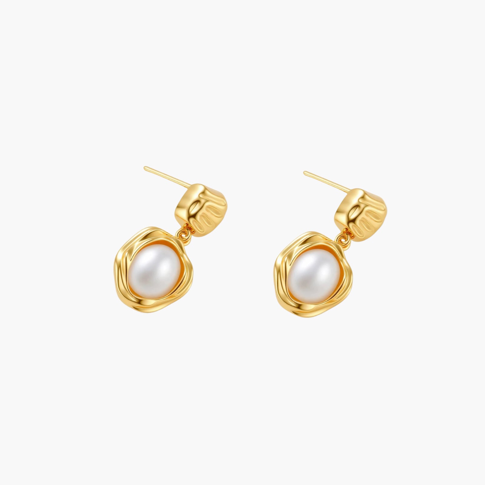 Gold-plated textured stud earrings with white freshwater pearl drops against cream background, showing organic rippled design