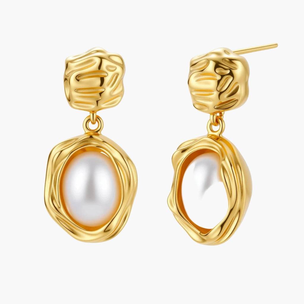 Gold-plated textured stud earrings with white freshwater pearl drops against cream background, showing organic rippled design