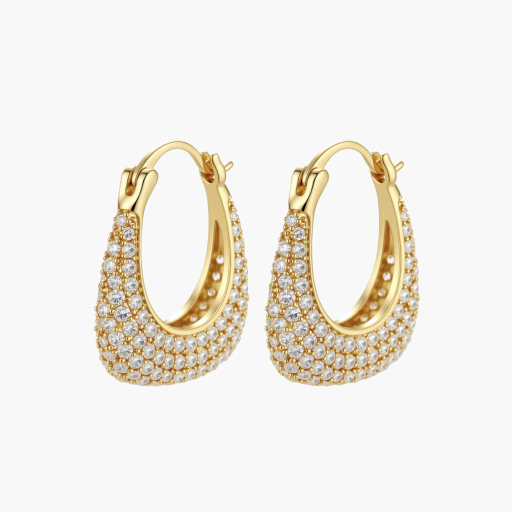 Gold-plated hoop earrings fully covered in sparkling zircon crystals with hinged closure on neutral background