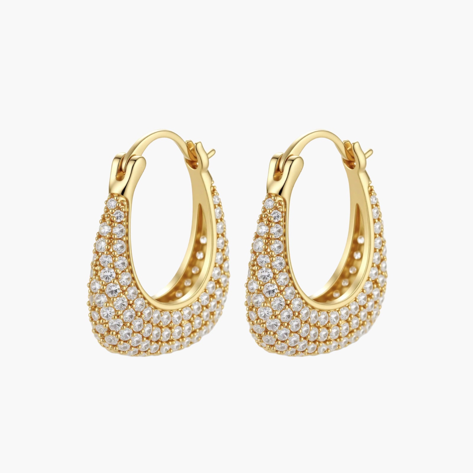 Gold-plated hoop earrings fully covered in sparkling zircon crystals with hinged closure on neutral background