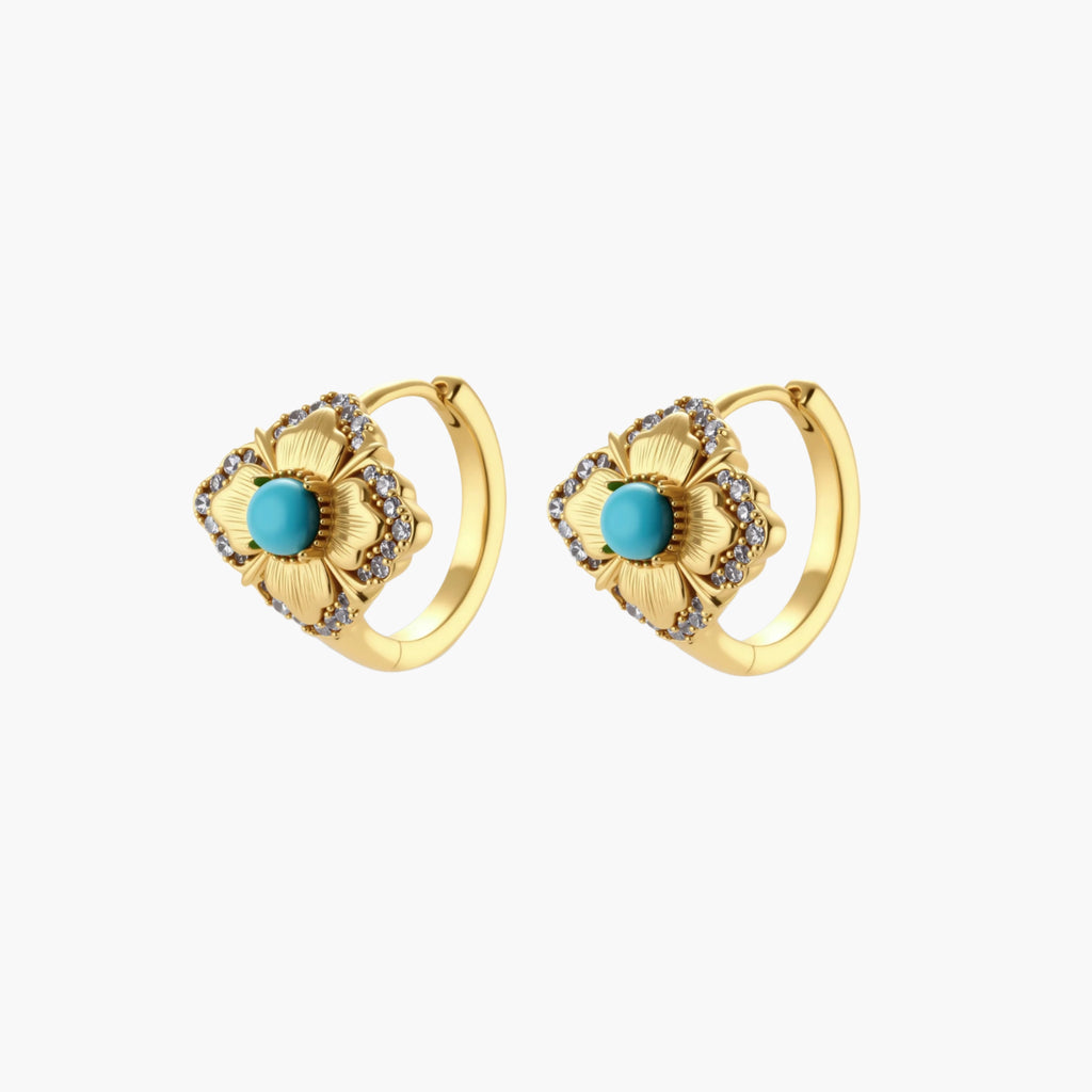 Close-up of 18K gold plated hoop earrings with turquoise center stones and zircon crystals in quatrefoil flower design
