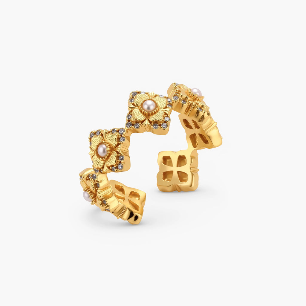 Gold-plated adjustable ring with multiple flower motifs, each featuring a central pearl and cubic zirconia stones