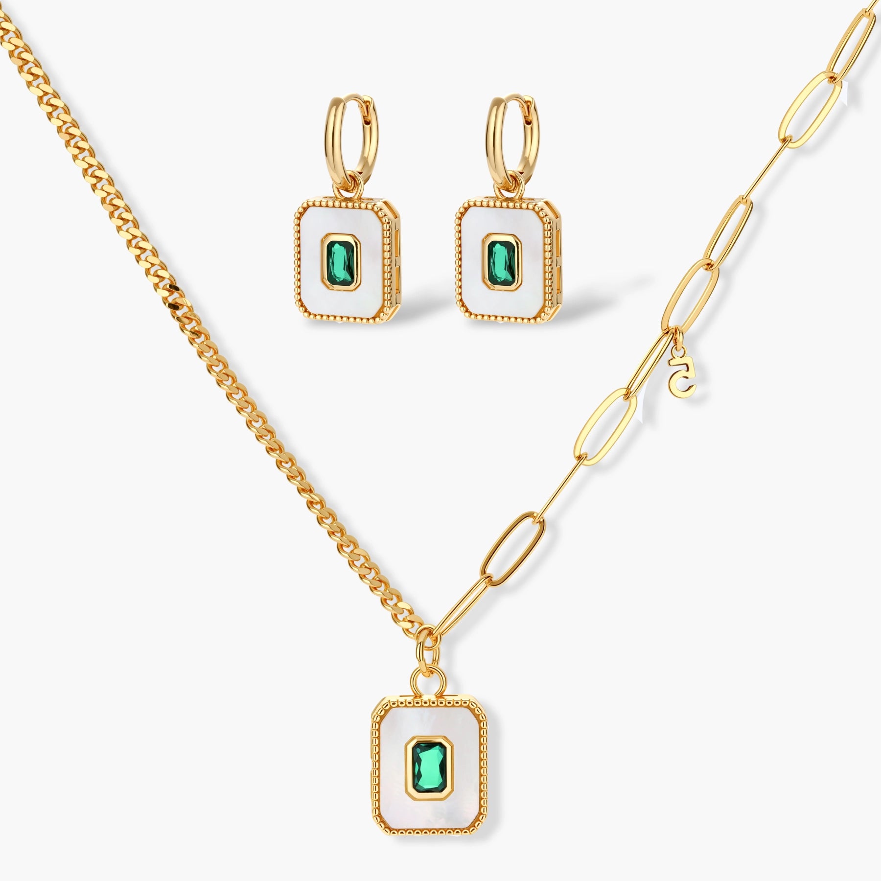 Gold-plated jewelry set with white enamel square pendants and emerald CZ stones on cream background.
