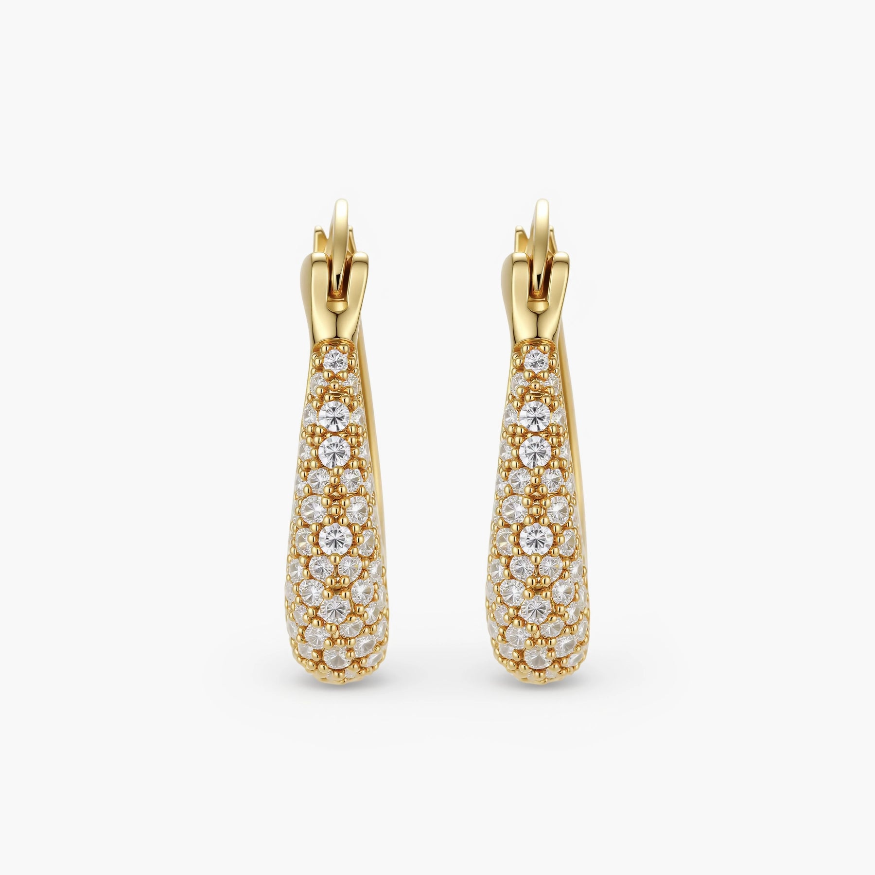 Gold-plated hoop earrings fully covered in sparkling zircon crystals with hinged closure on neutral background