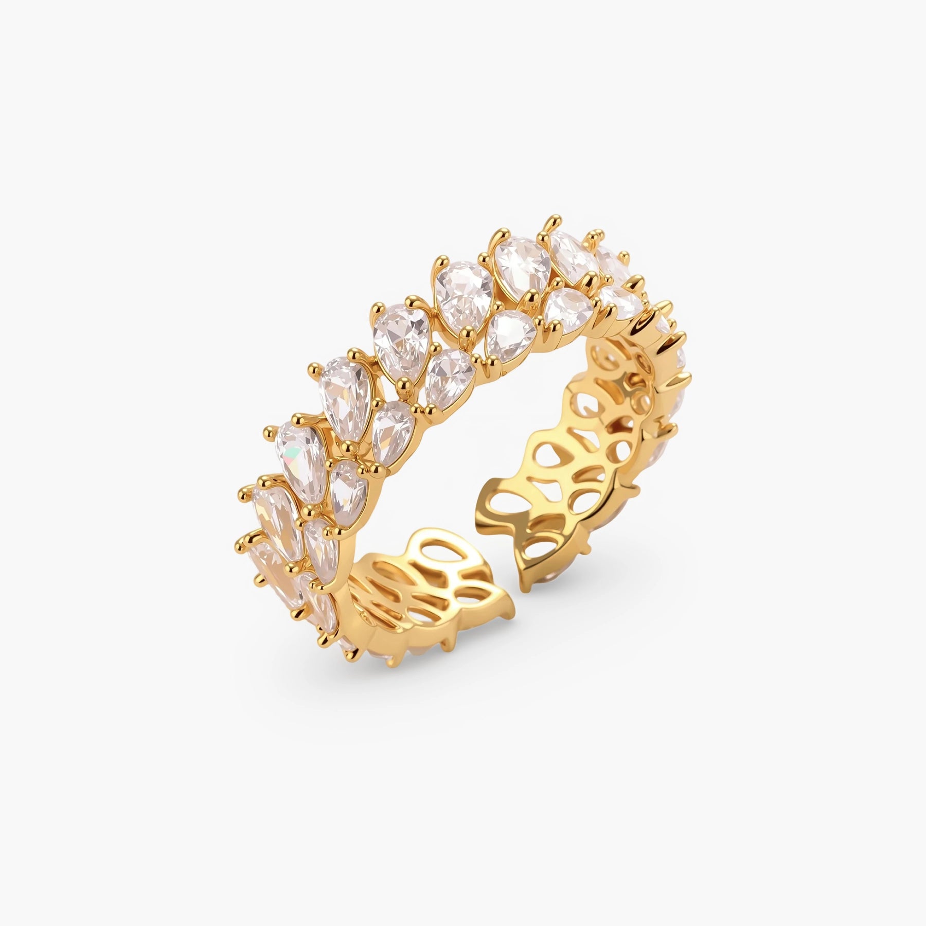 Adjustable gold-plated ring with double-row pear-shaped cubic zirconia stones in geometric pattern on cream background.