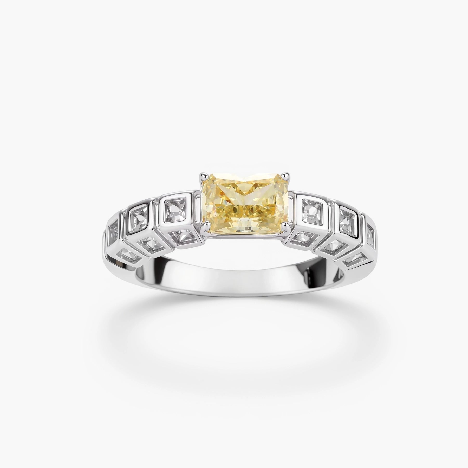 Adjustable ring with emerald-cut yellow zirconia center and clear accent stones in geometric platinum-plated setting