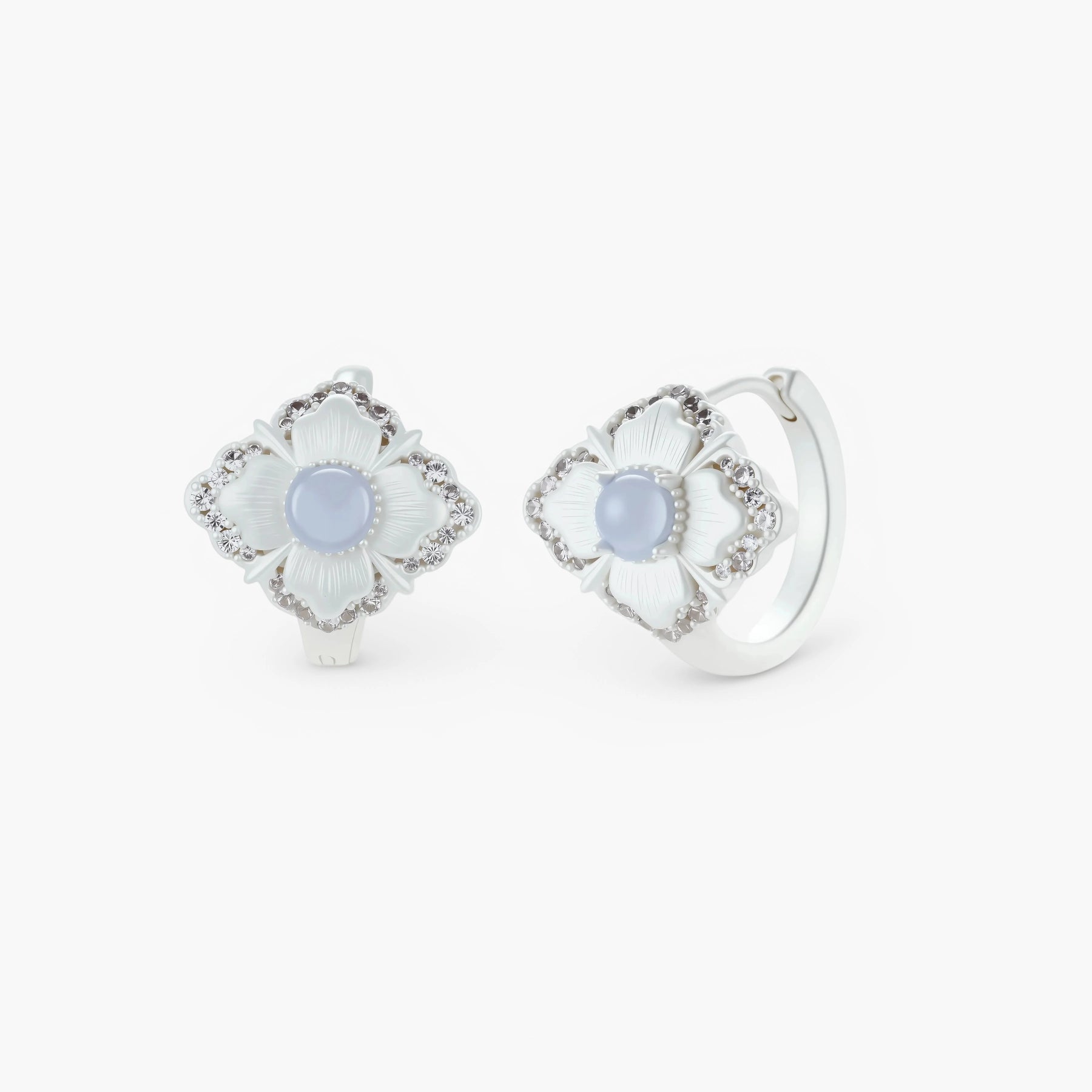 Silver-plated flower earrings with blue zirconia centers, featuring one stud and one huggie hoop in mismatched pair style.