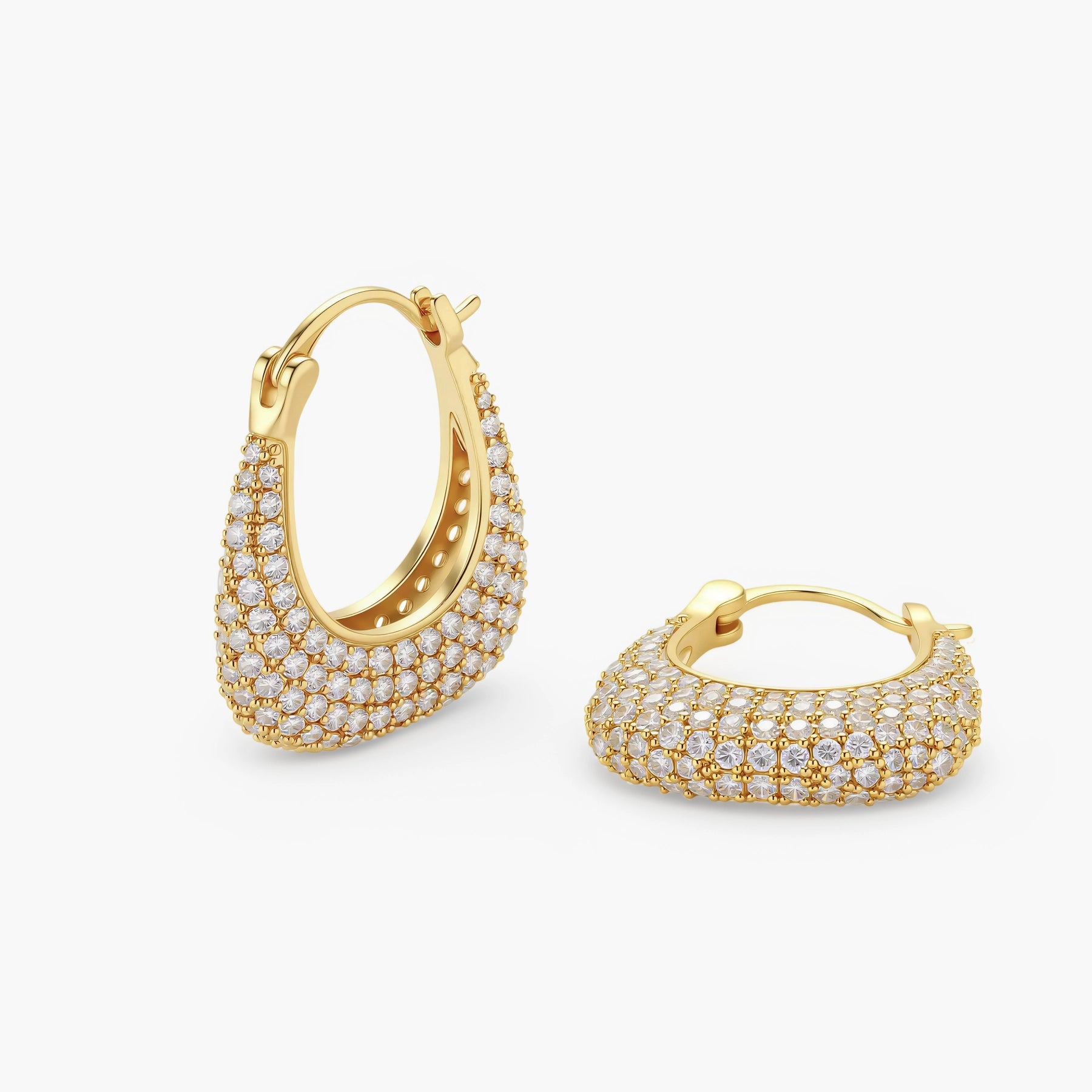 Gold-plated hoop earrings fully covered in sparkling zircon crystals with hinged closure on neutral background