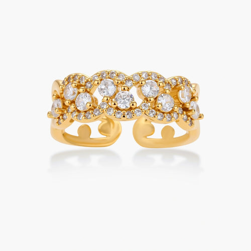 Adjustable gold-plated ring with multiple crystal clusters in intricate chain design on cream background.