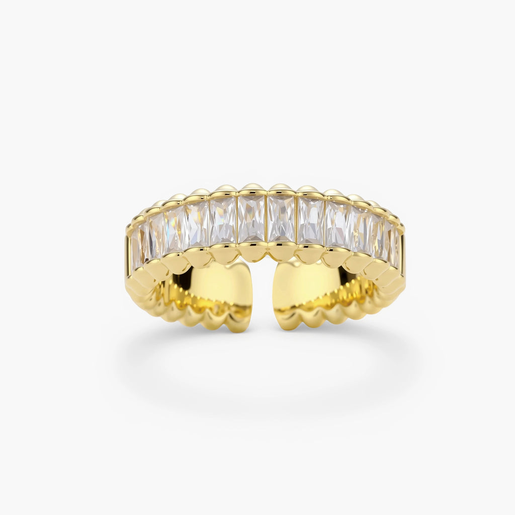 Adjustable gold-plated ring with rectangular cubic zirconia stones in eternity band style on neutral background.