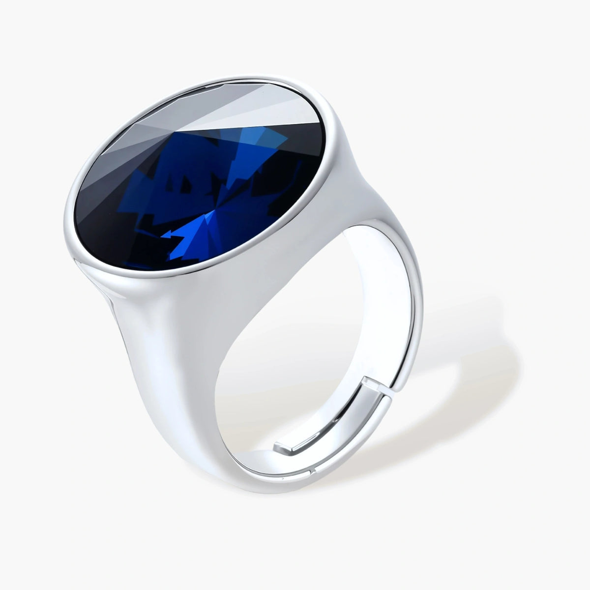 Large oval blue cubic zirconia ring in palladium-plated setting with adjustable band design on neutral background.