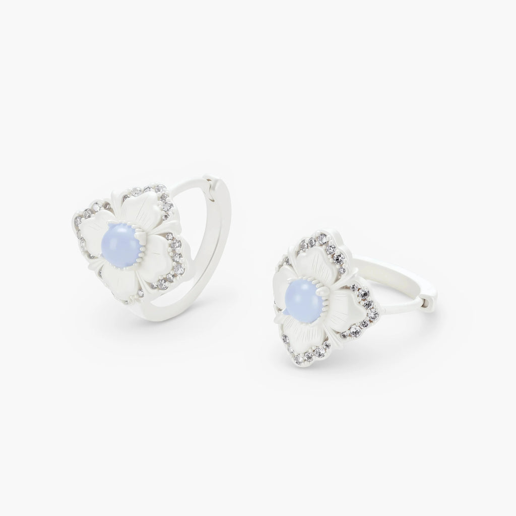 Silver-plated flower earrings with blue zirconia centers, featuring one stud and one huggie hoop in mismatched pair style.