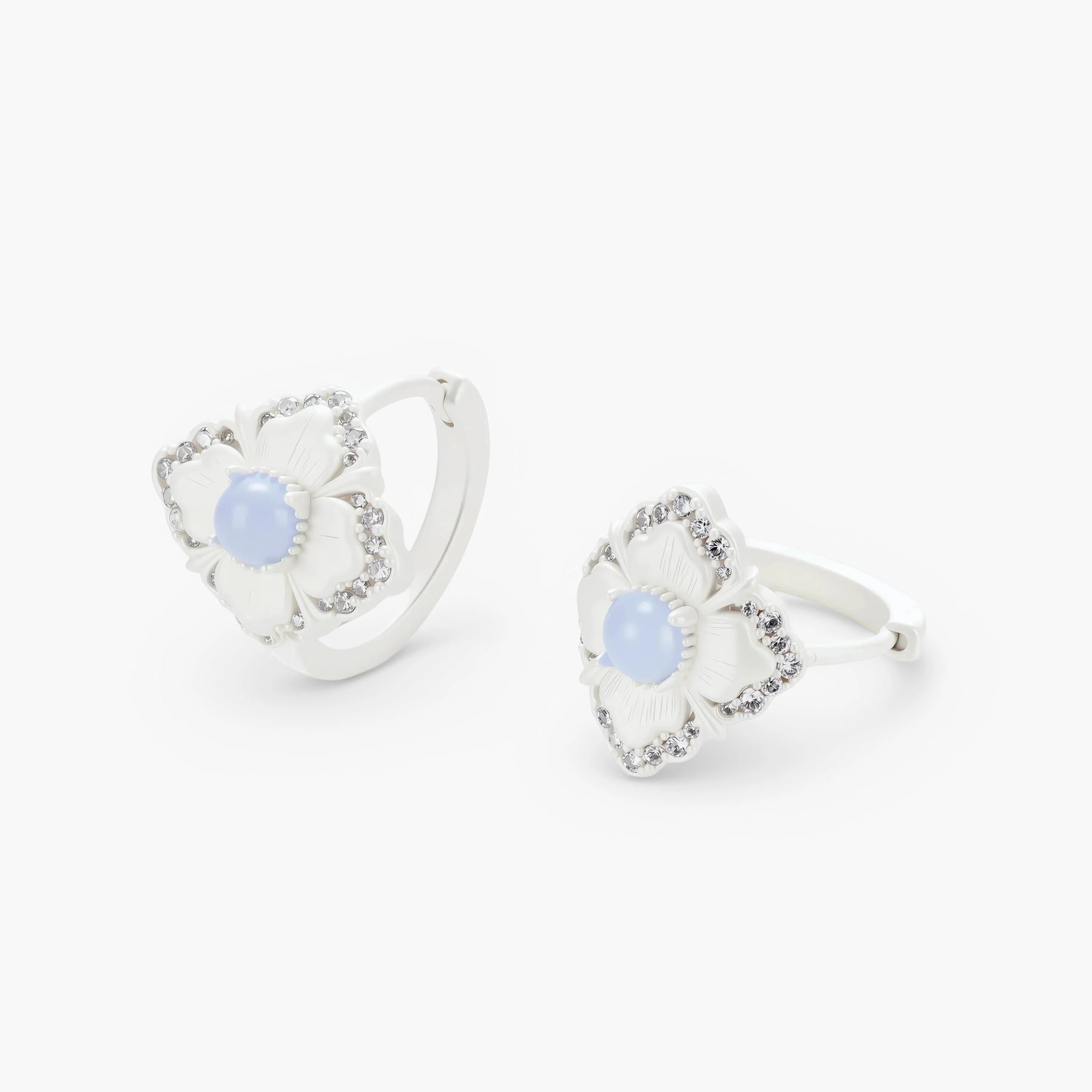 Silver-plated flower earrings with blue zirconia centers, featuring one stud and one huggie hoop in mismatched pair style.