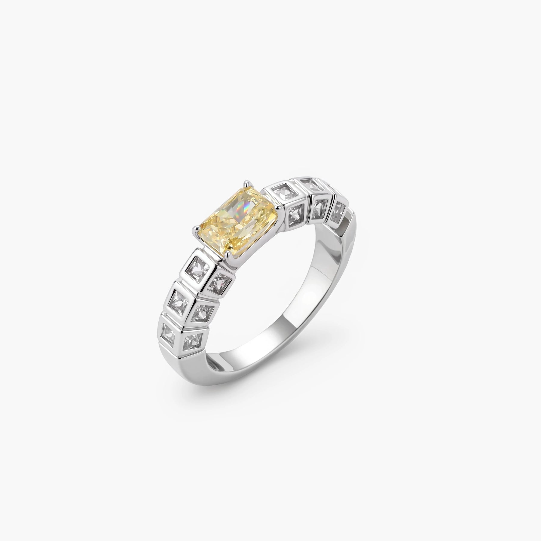 Adjustable ring with emerald-cut yellow zirconia center and clear accent stones in geometric platinum-plated setting
