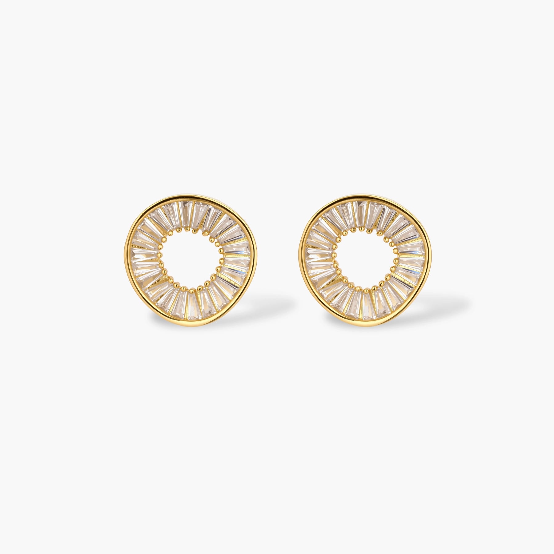 Gold-plated necklace and earring set with circular CZ crystal pendants featuring radial design on cream background
