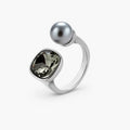 Modern adjustable ring with smoky zircon stone and metallic sphere in platinum-plated copper finish on neutral background.
