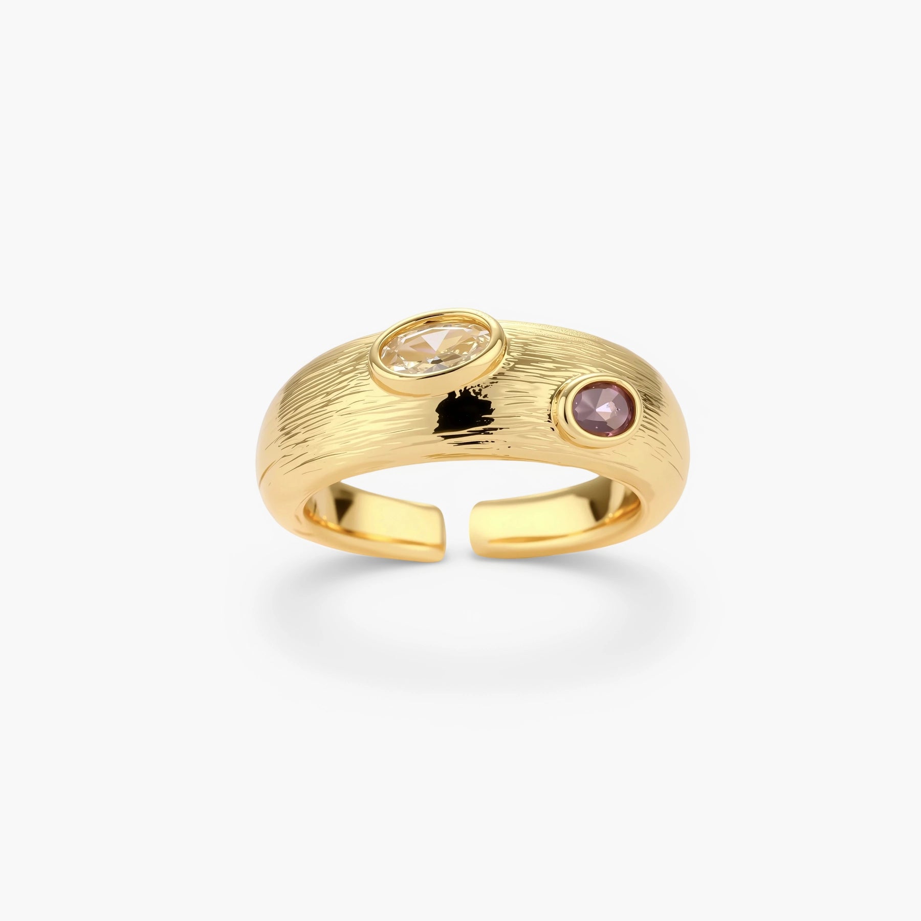 Gold-plated adjustable ring with textured band featuring champagne and purple gemstones on white background.