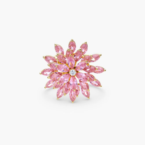 Pink cubic zirconia brooch in floral starburst design with palladium-plated copper setting on white background.